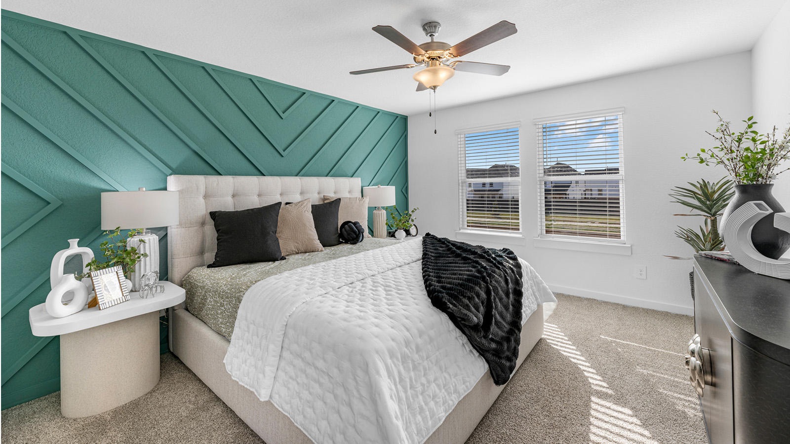 A spacious primary bedroom emphasizing open space and natural lighting with large windows.