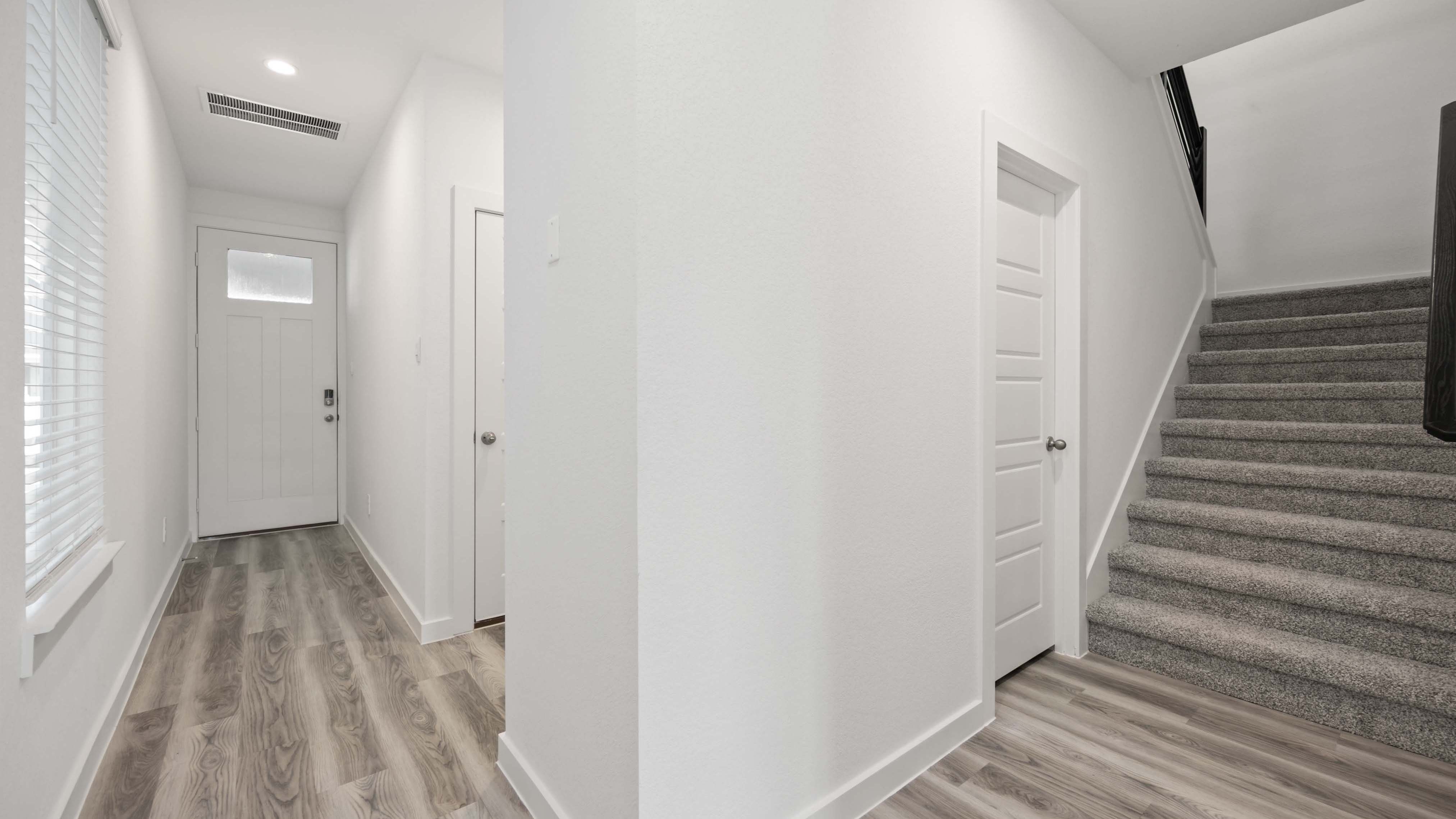 Spacious entry foyer with grand staircase leading to the second floor
