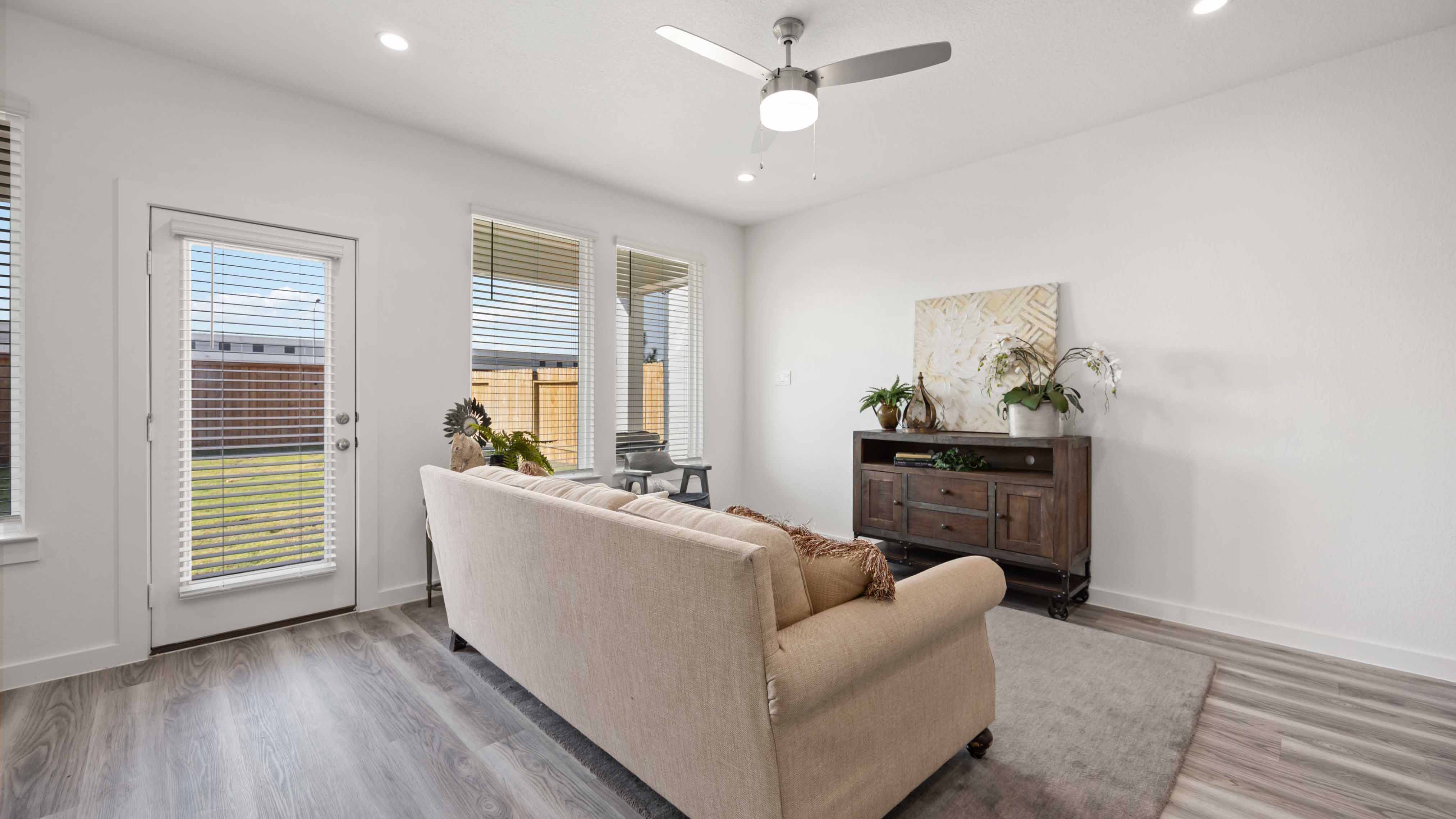 A well-organized living room that includes a kitchen and dining area, creating a warm and welcoming environment for gatherings.