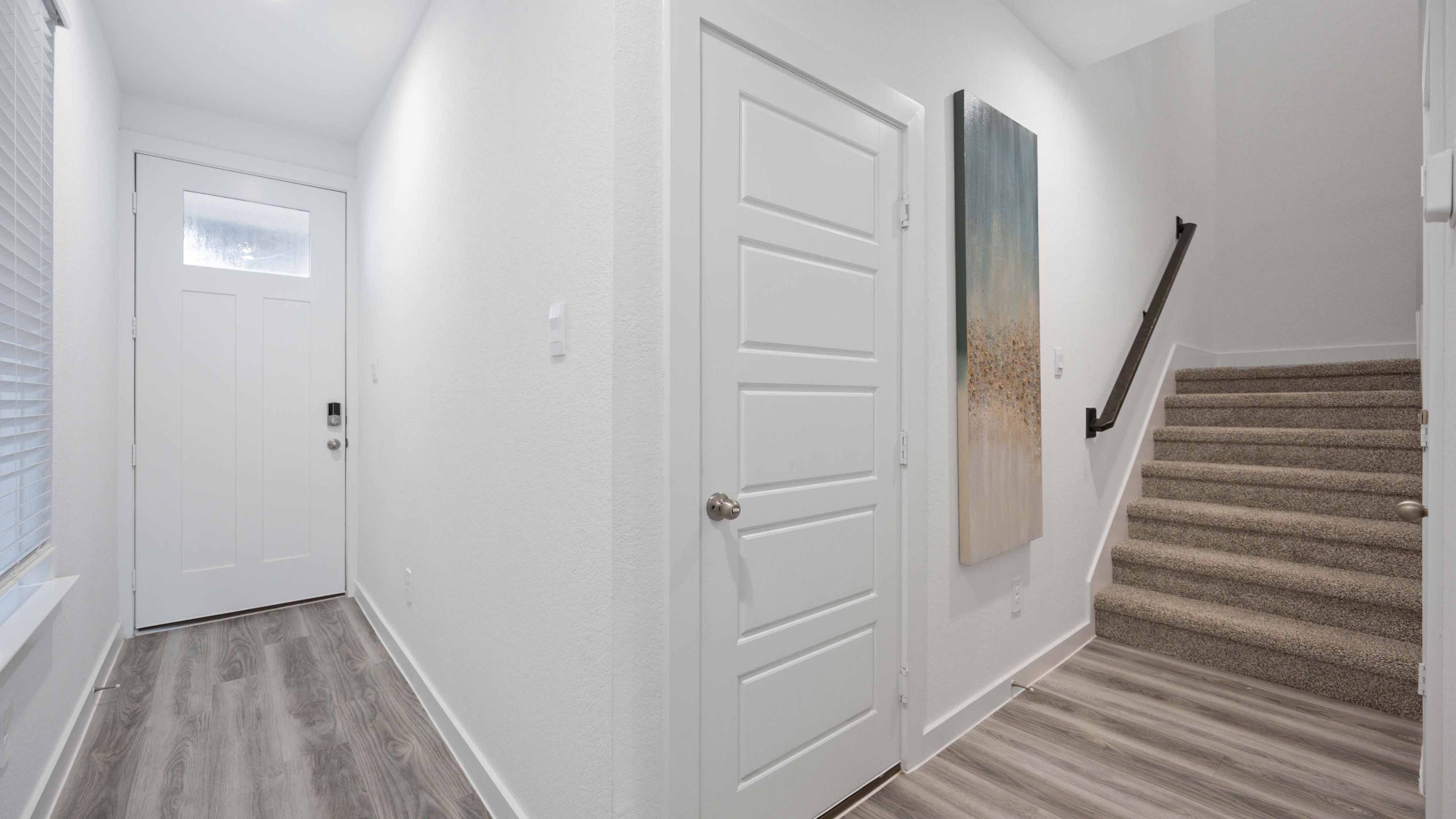 Spacious entry foyer with grand staircase leading to the second floor
