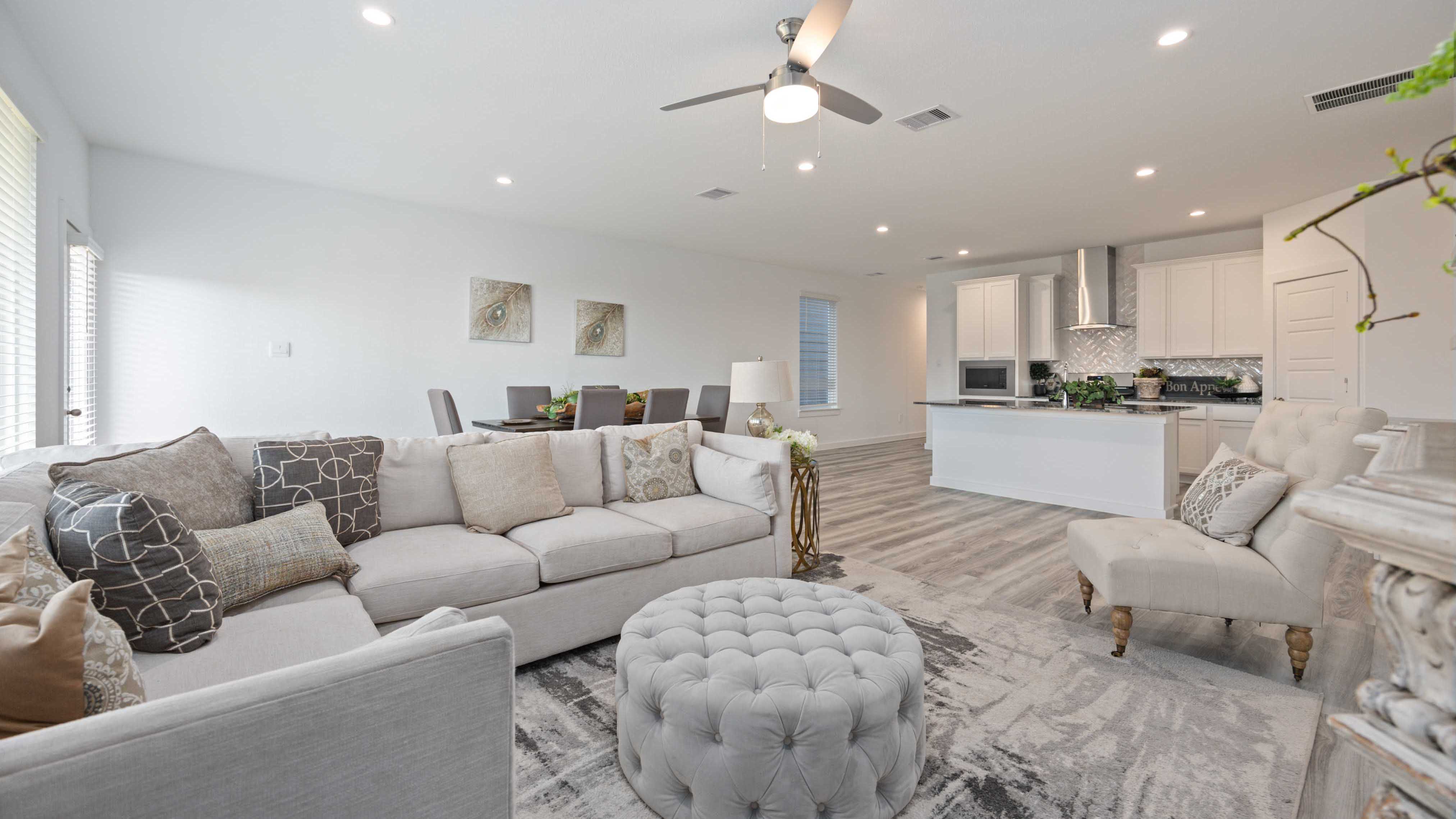 A well-organized living room that includes a kitchen and dining area, creating a warm and welcoming environment for gatherings.