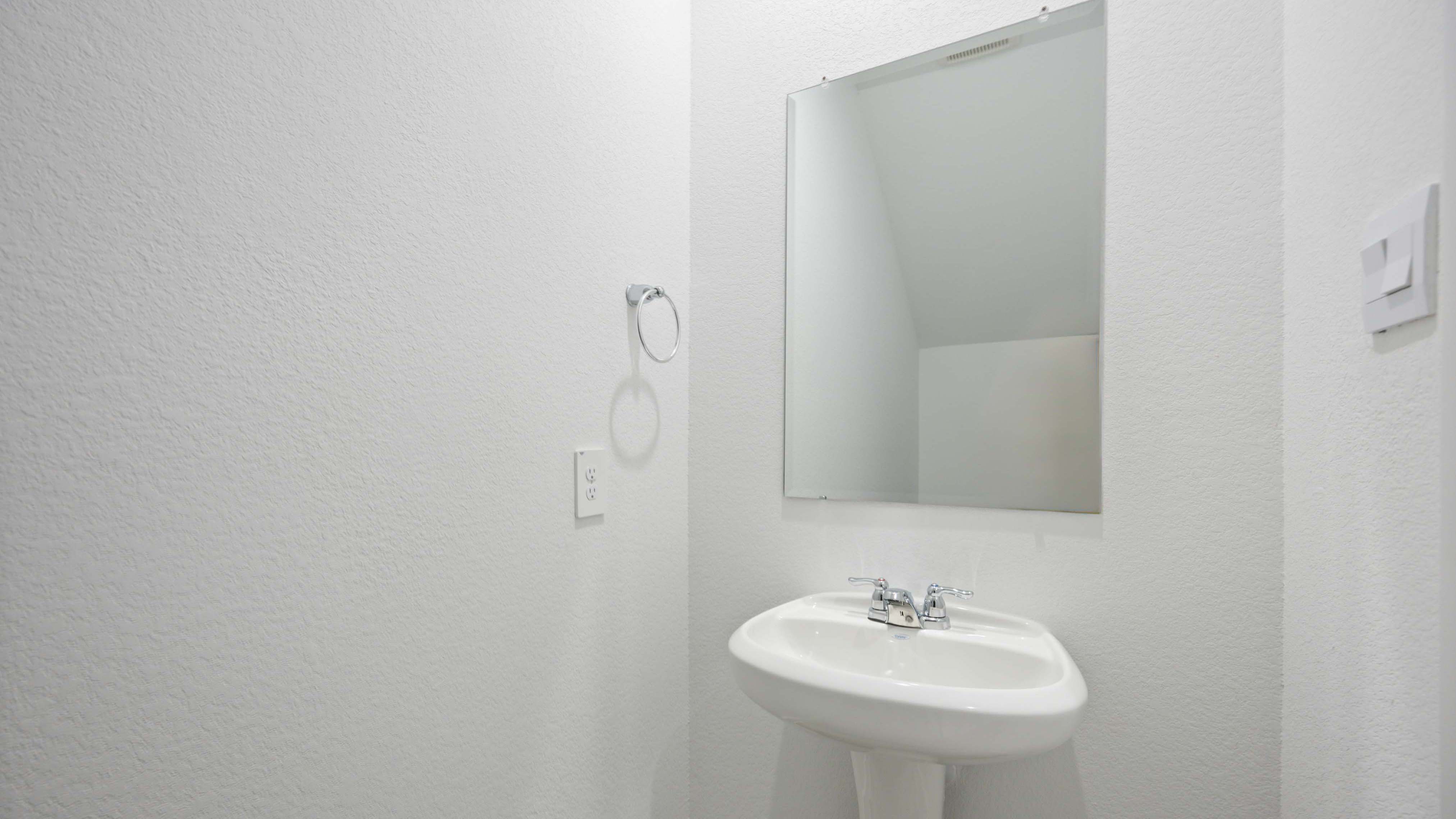 A decorated half bathroom downstairs for guests