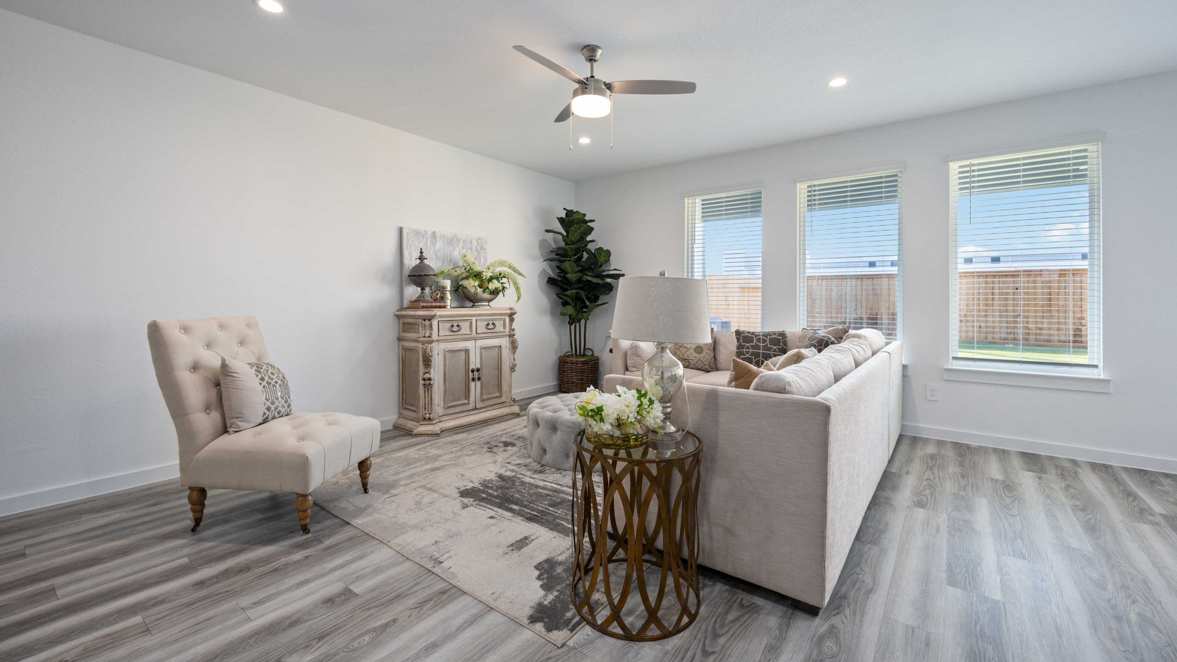 A cozy living room featuring a comfortable couch, a stylish coffee table, and an elegant painting on the wall.