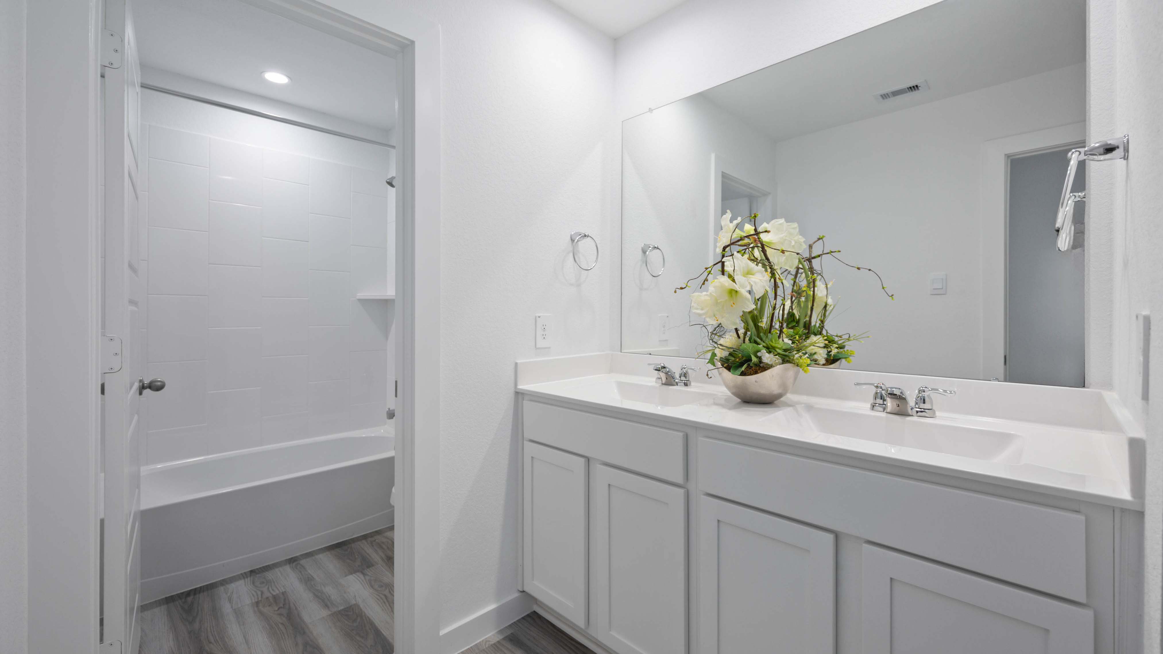 Primary bathroom with a glass-enclosed standing shower and separate soaking tub.
