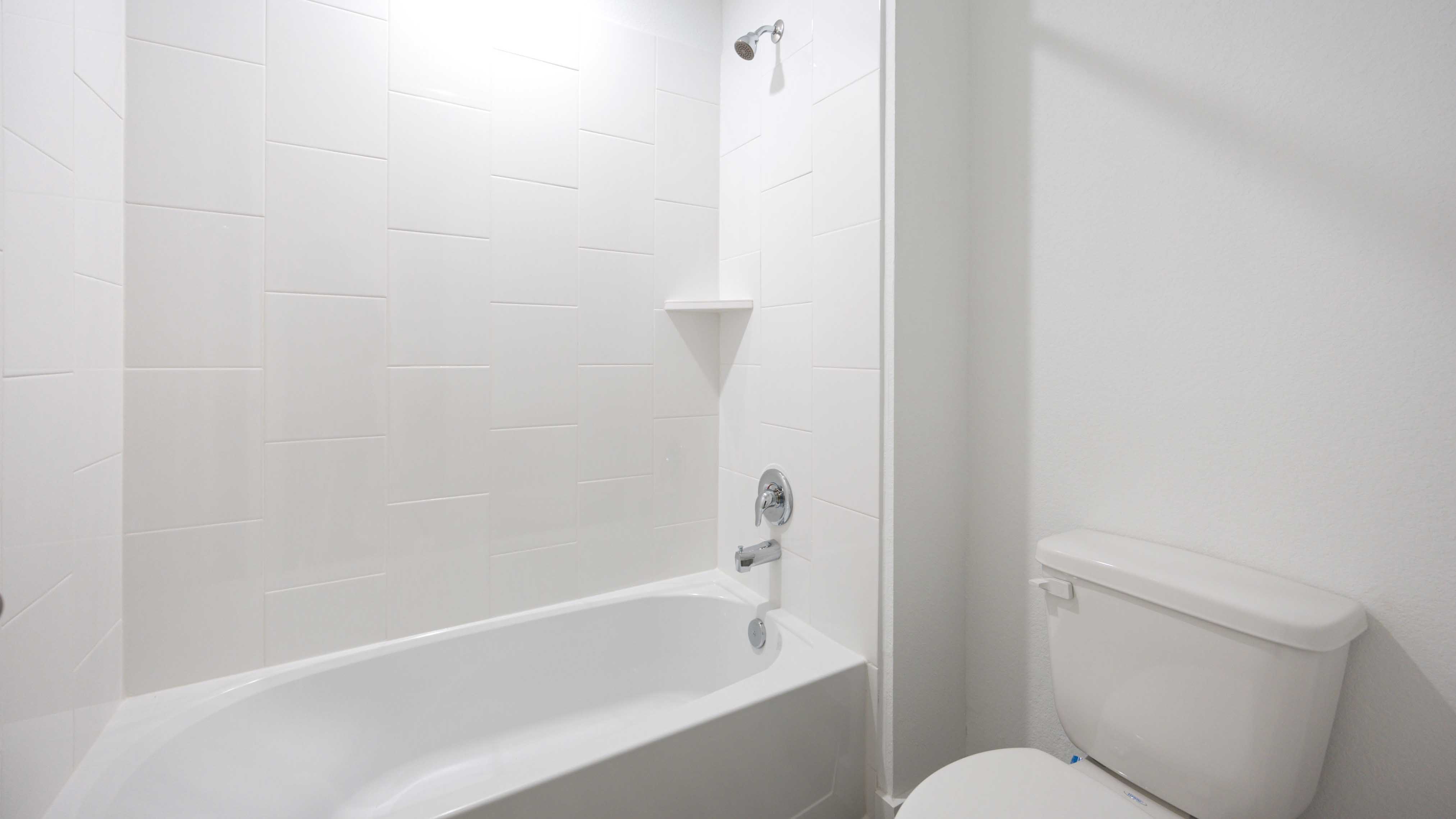 A well-designed bathroom equipped with quartz countertops, a standing tub, and a single vanity.