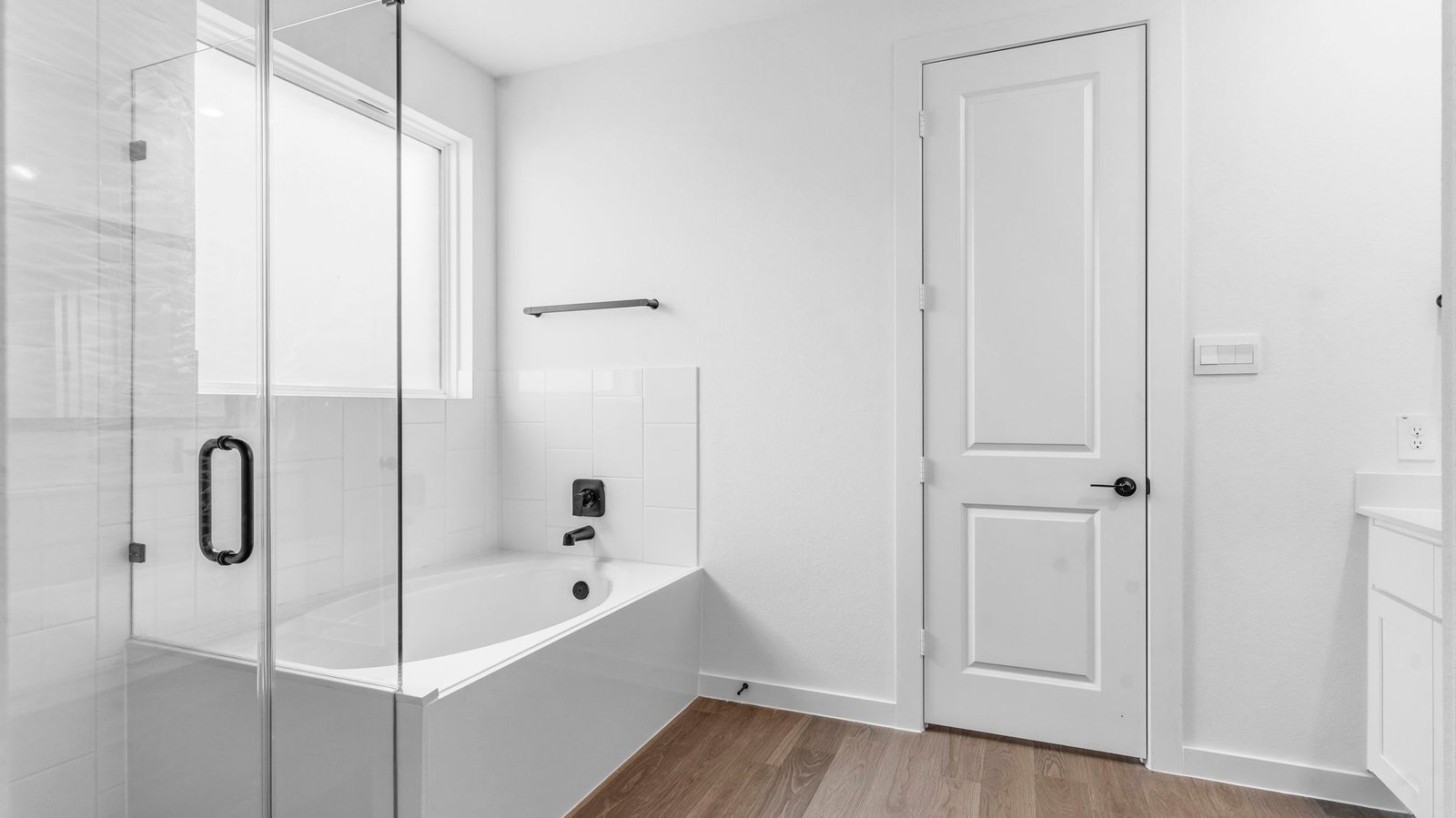 Primary bathroom with a glass-enclosed standing shower and separate soaking tub.