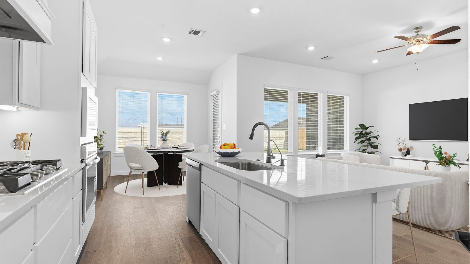 Kitchen adorned with painted cabinets seamlessly integrated into an open dining area layout.