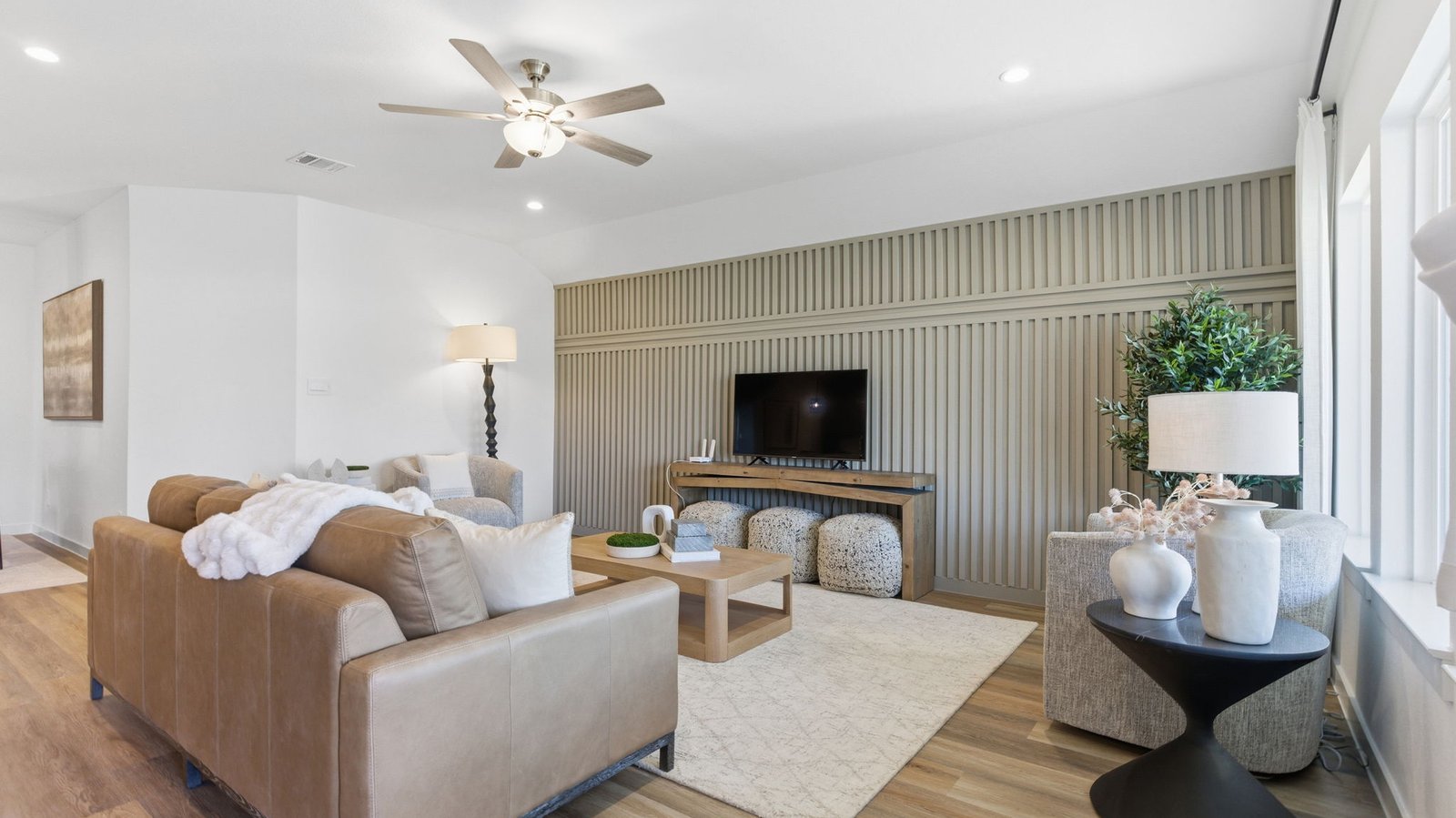 A cozy living room featuring a comfortable couch, a stylish coffee table, and an elegant painting on the wall.
