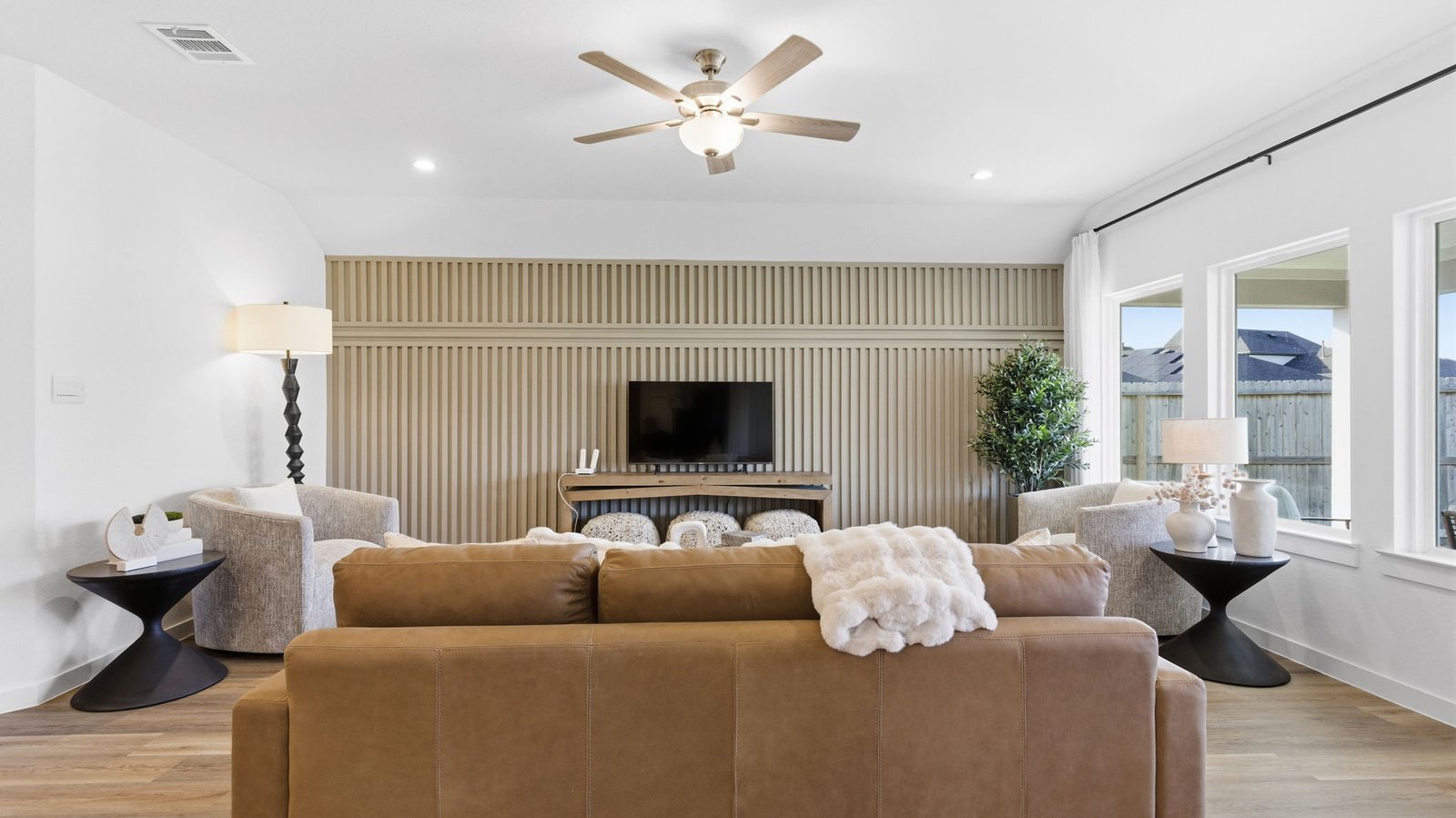 A cozy living room featuring a comfortable couch, a stylish coffee table, and an elegant painting on the wall.