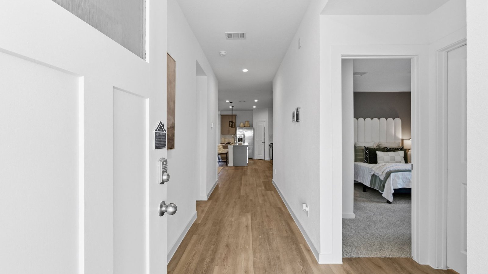 Entry hallway leading to living room and kitchen in the background.