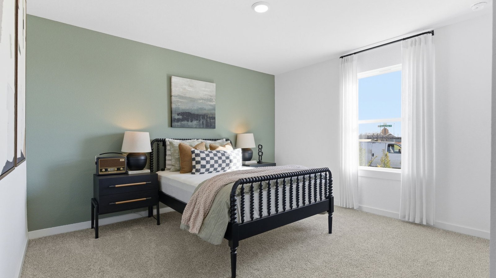Comfortable guest bedroom featuring neutral-toned walls, carpeted flooring, and a separate closet.