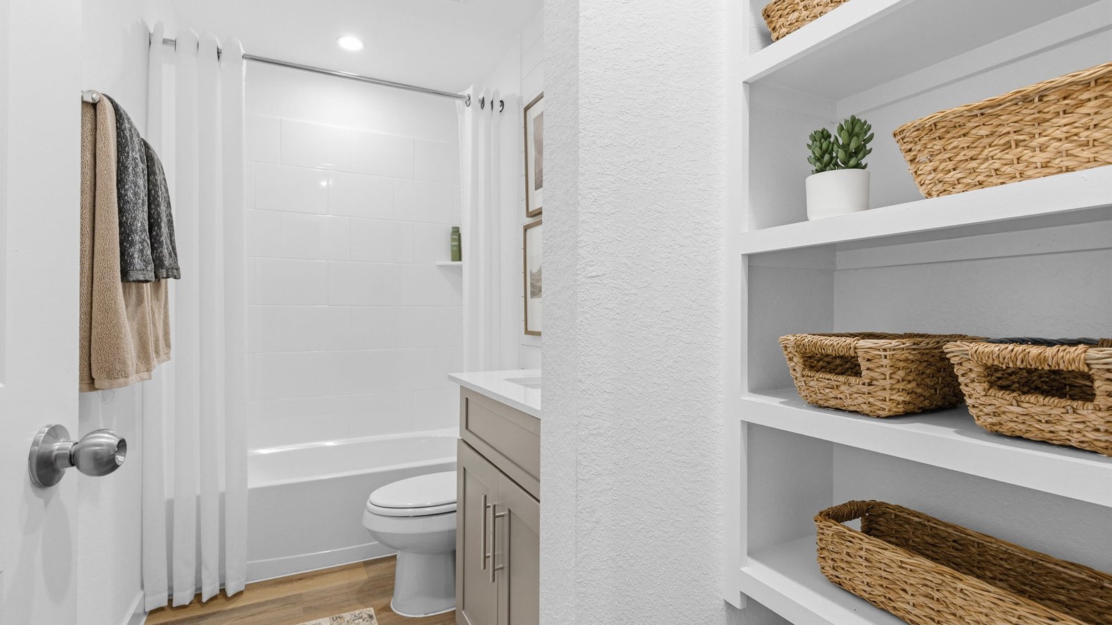 A well-designed bathroom equipped with quartz countertops, a standing tub, and a single vanity.