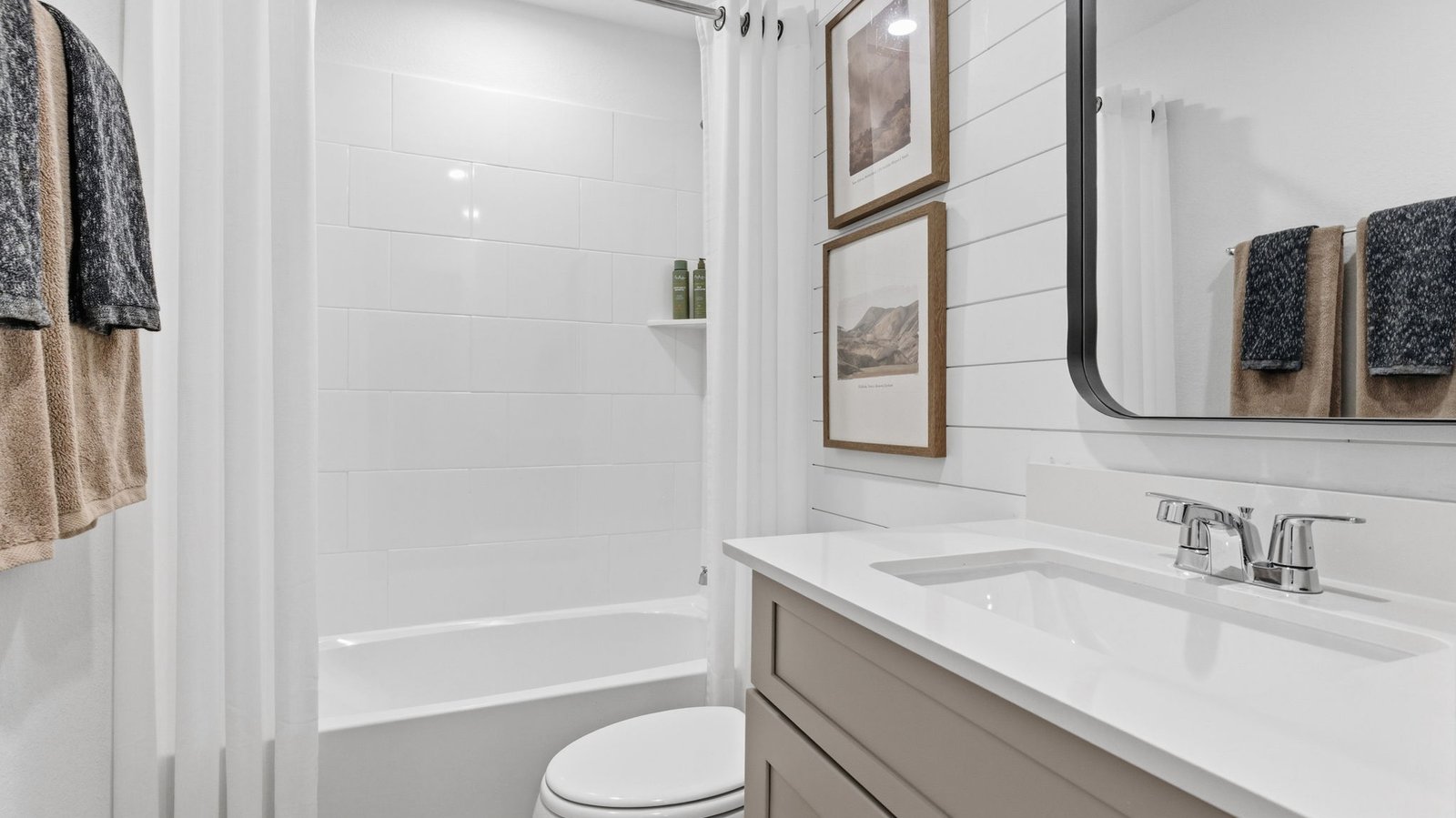 A well-designed bathroom equipped with quartz countertops, a standing tub, and a single vanity.