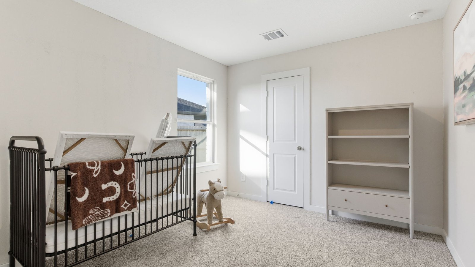 A third bedroom with neutral walls, plush carpet flooring and a separate closet.