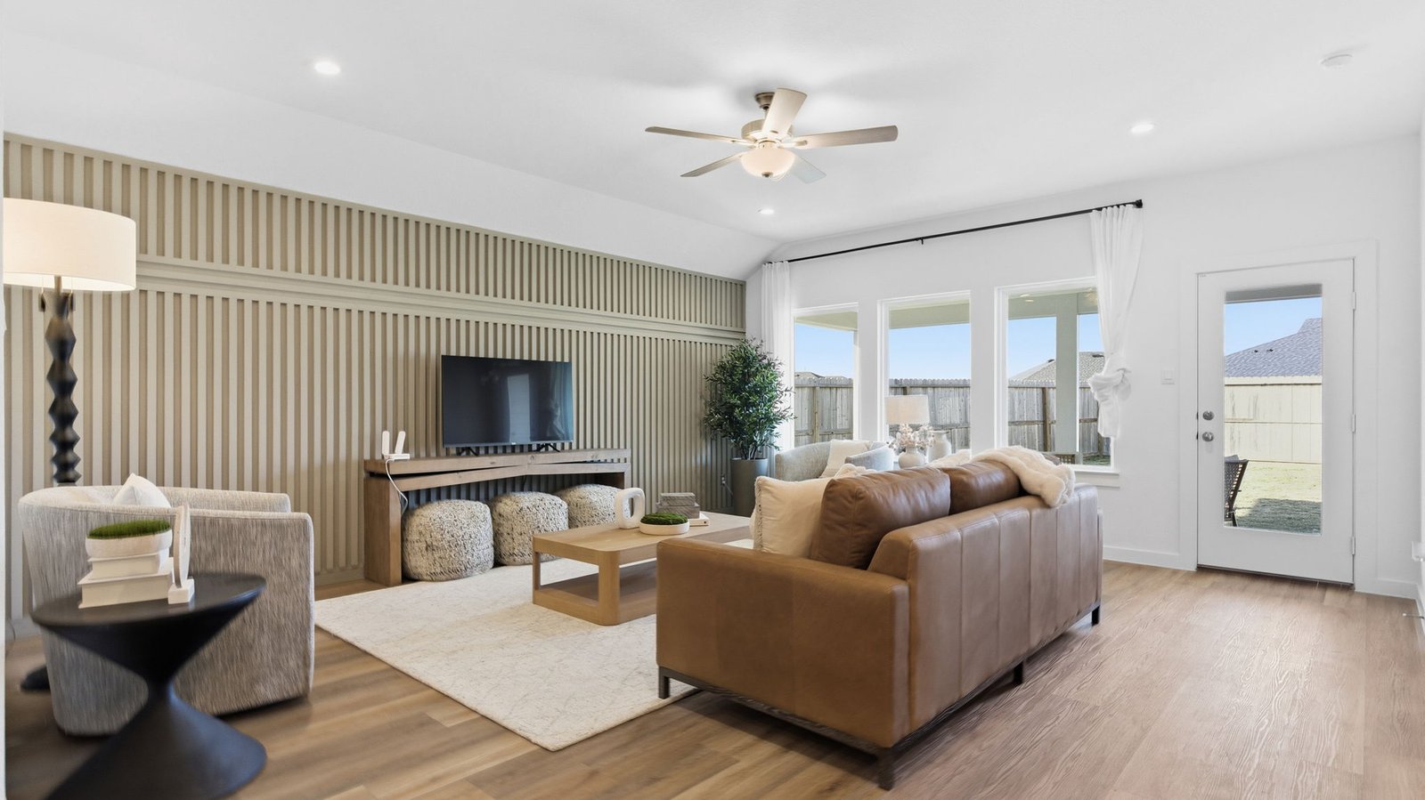 A well-organized living room that includes a kitchen and dining area, creating a warm and welcoming environment for gatherings.