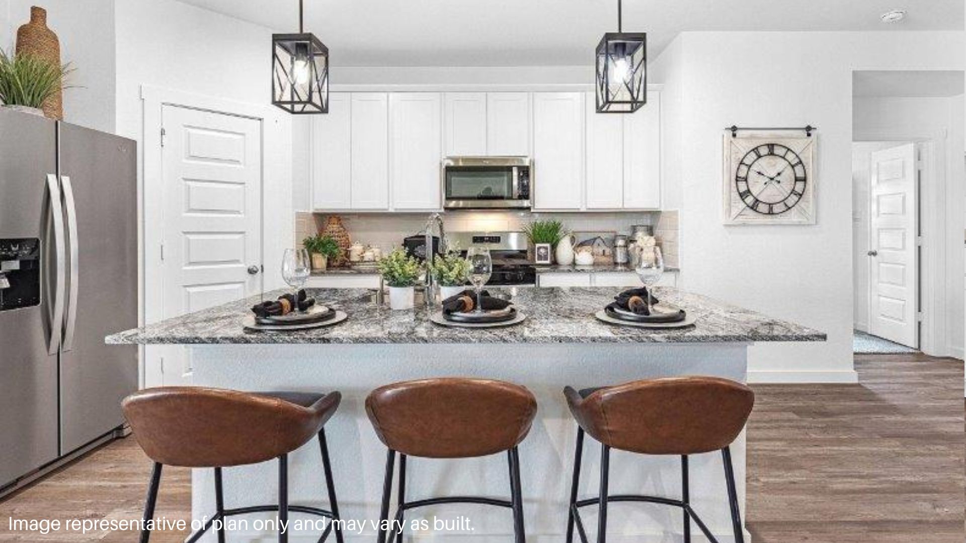 Center Island in Kitchen with White Cabinets and Stainless steel appliances
