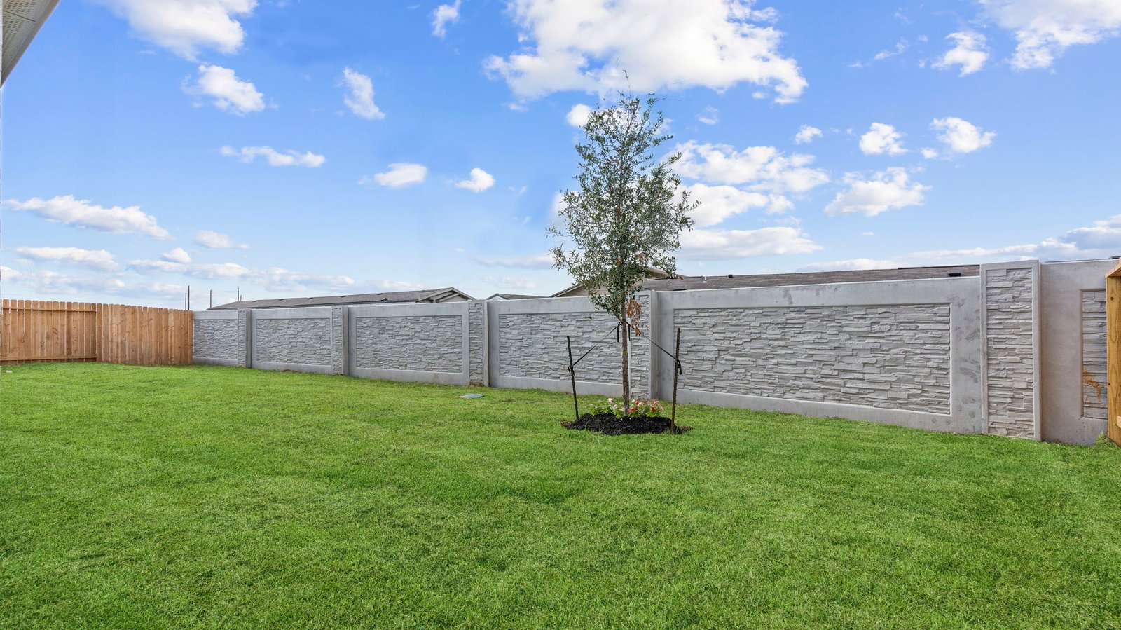 Large fenced-in backyard with a covered patio, perfect for outdoor entertaining.