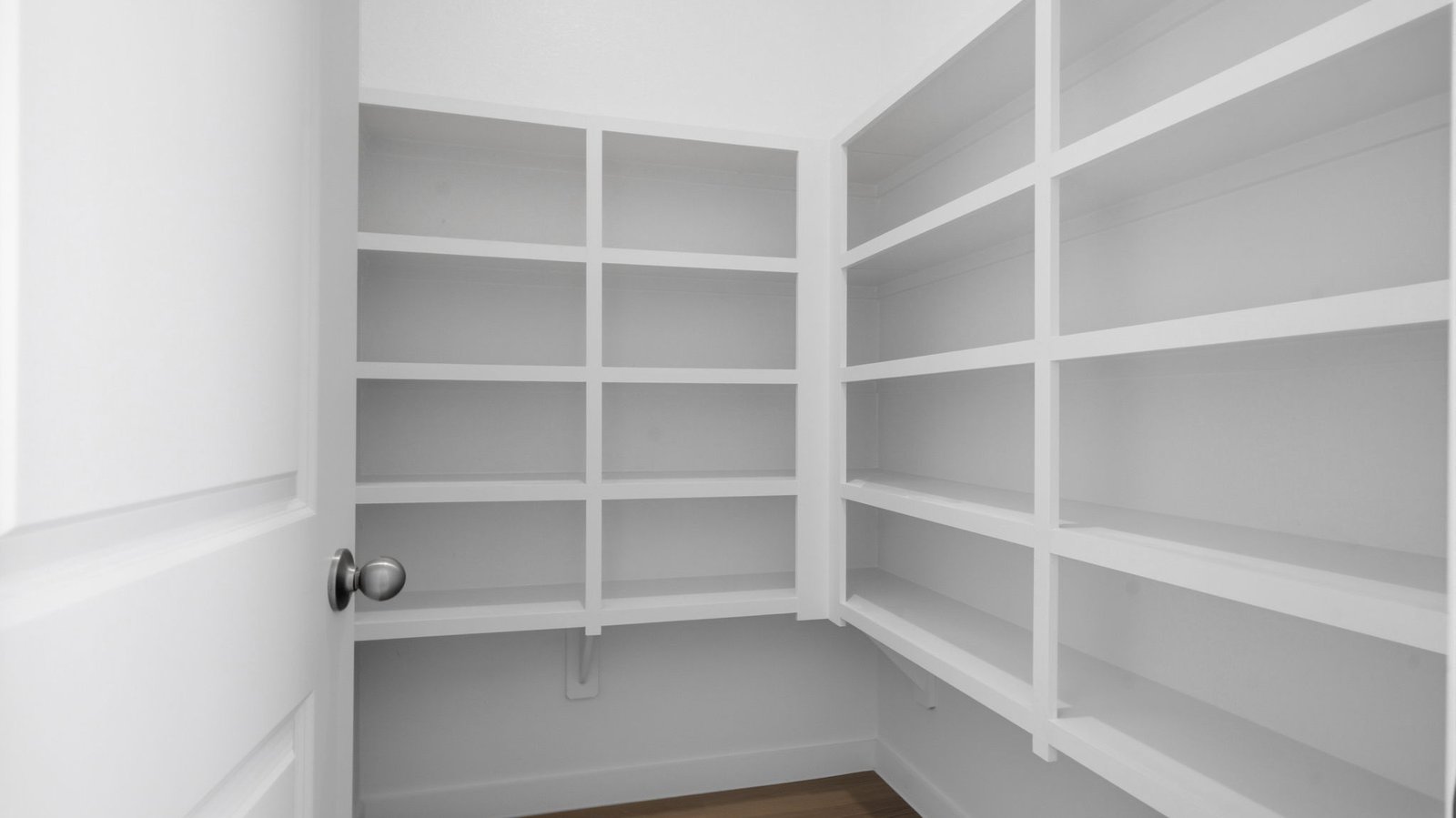 Walk-in pantry off the kitchen with built in shelves for maximum storage