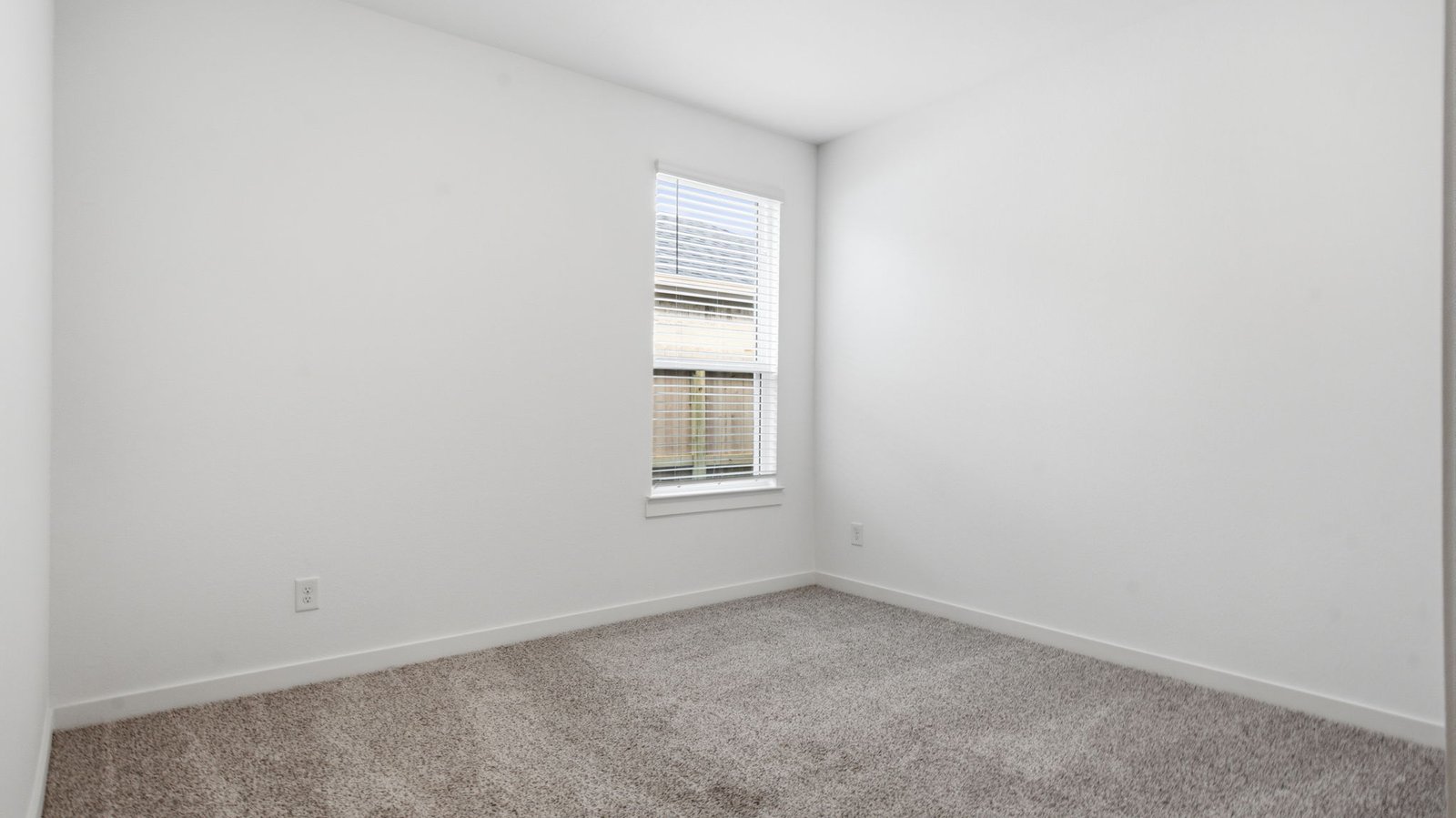 Third bedroom with neutral walls, plush carpet flooring and a separate closet.