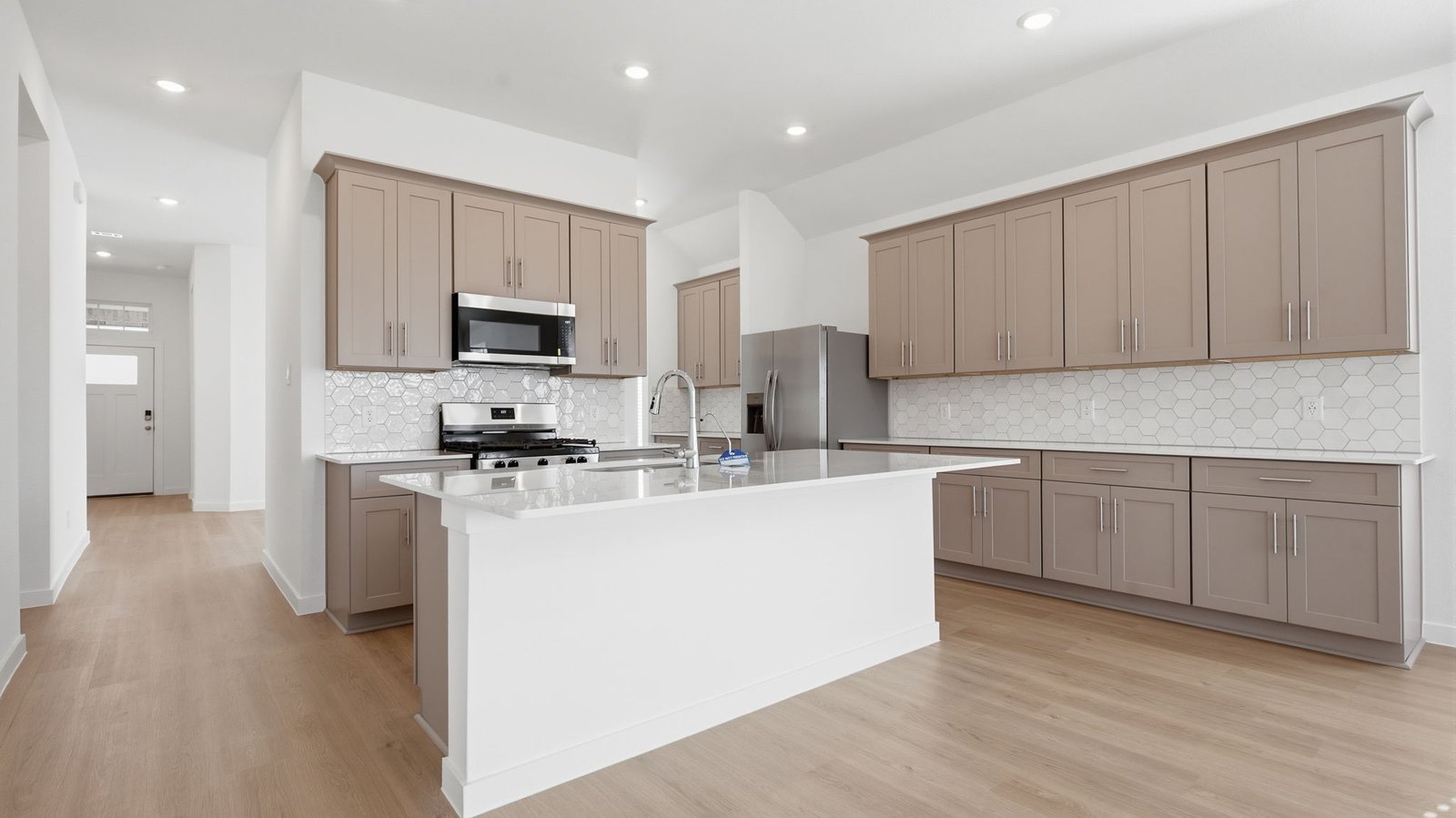 Contemporary kitchen adorned with stained wood cabinets seamlessly integrated into an open dining area layout.