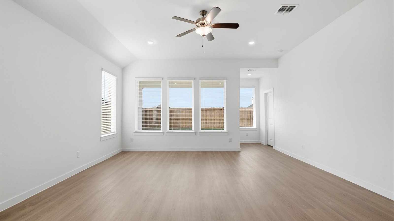 A well-organized living room that includes a kitchen and dining area, creating a warm and welcoming environment for gatherings.