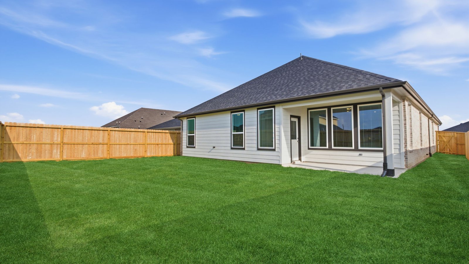 Large fenced-in backyard with a covered patio, perfect for outdoor entertaining