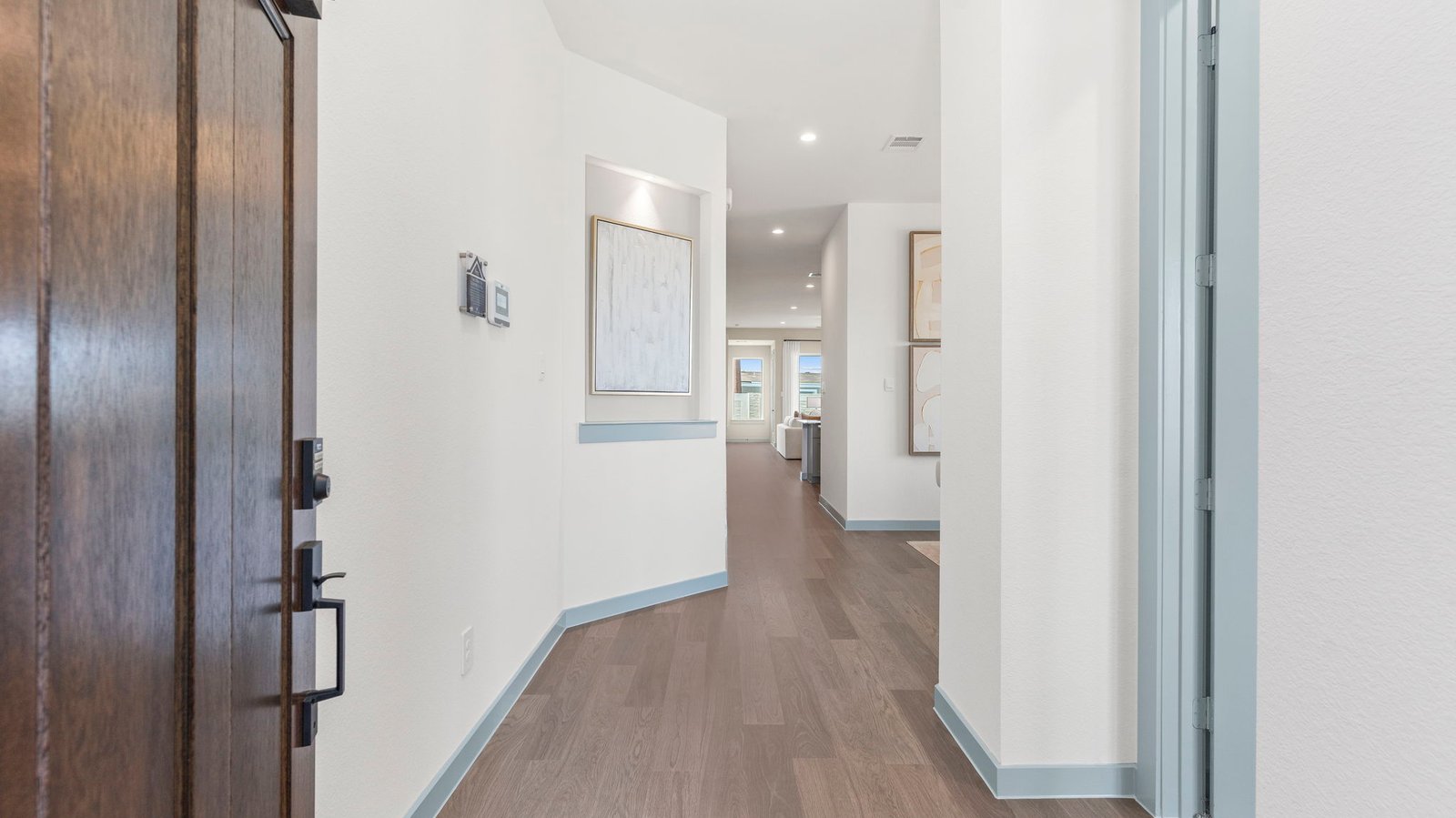 Entry hallway leading to living room and kitchen in the background.