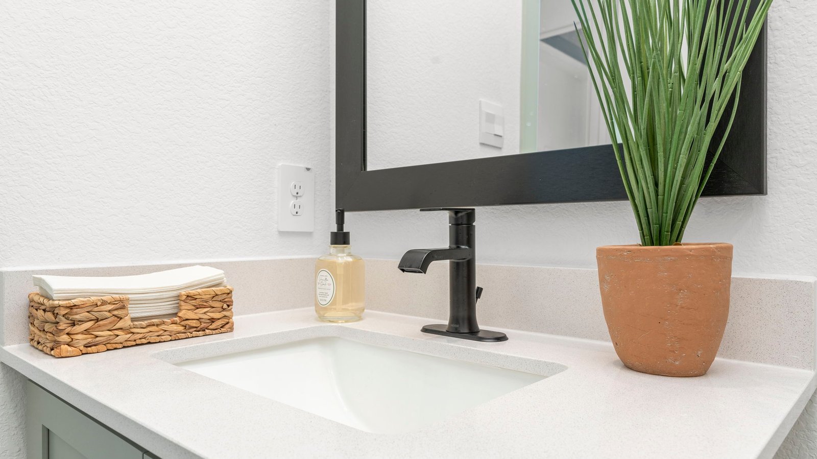 A well-designed bathroom equipped with quartz countertops, a standing tub, and a single vanity.
