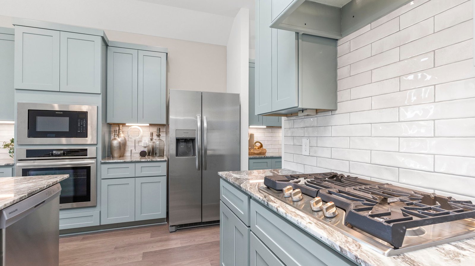 An open concept kitchen with an island with bar seating and access to the living and dining areas.