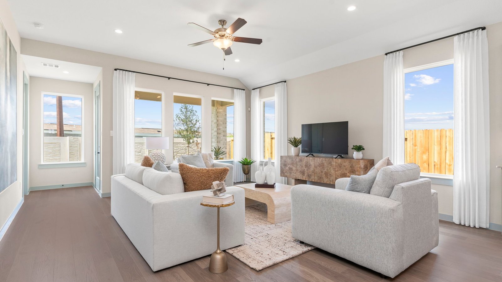 A well-organized living room that includes a kitchen and dining area, creating a warm and welcoming environment for gatherings.