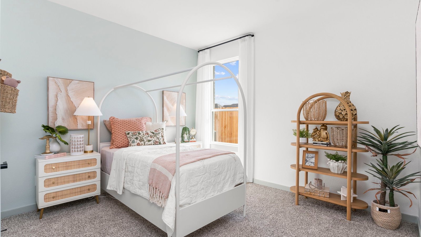A vibrant bedroom showcasing a neatly made bed, a stylish dresser, and a playful painting that adds charm.