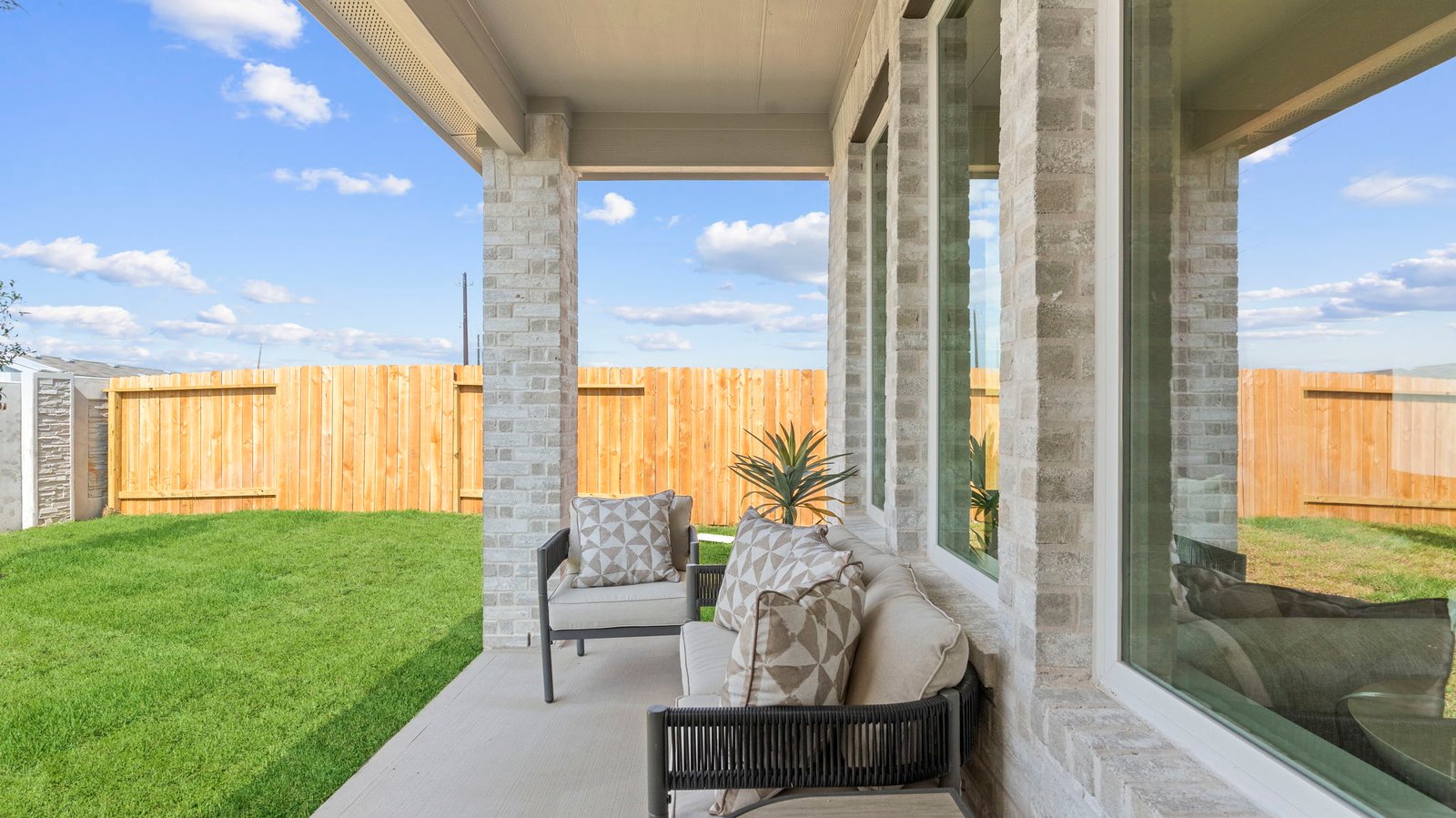 Large fenced-in backyard with a covered patio, perfect for outdoor entertaining.
