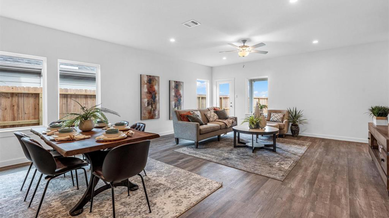 A well-organized living room that includes a kitchen and dining area, creating a warm and welcoming environment for gatherings.