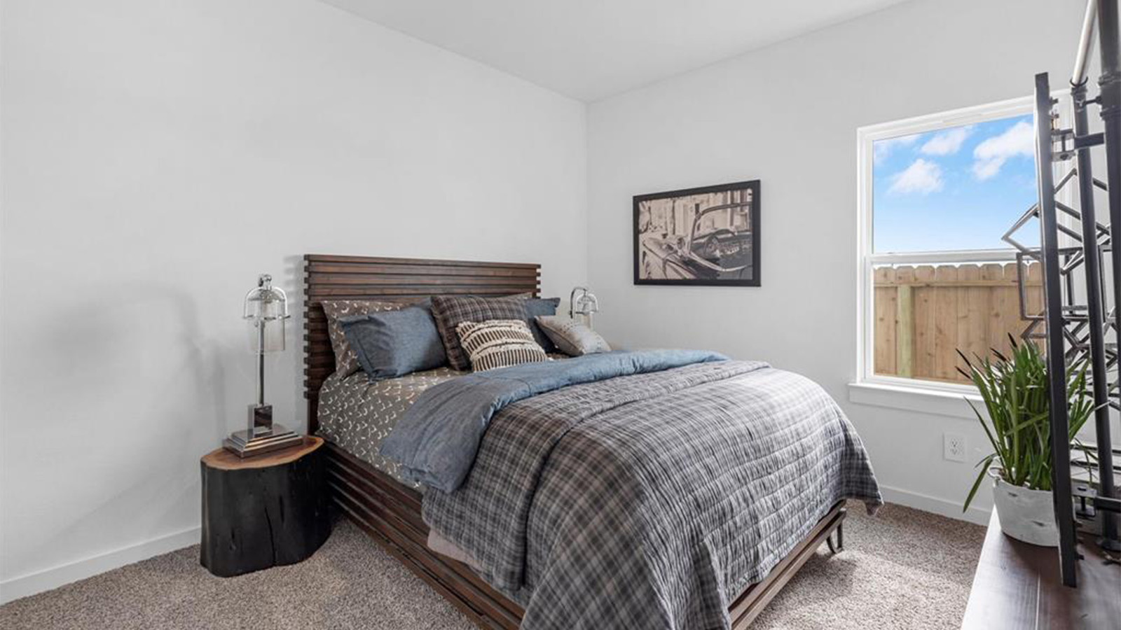 A third bedroom with neutral walls, plush carpet flooring and a separate closet.