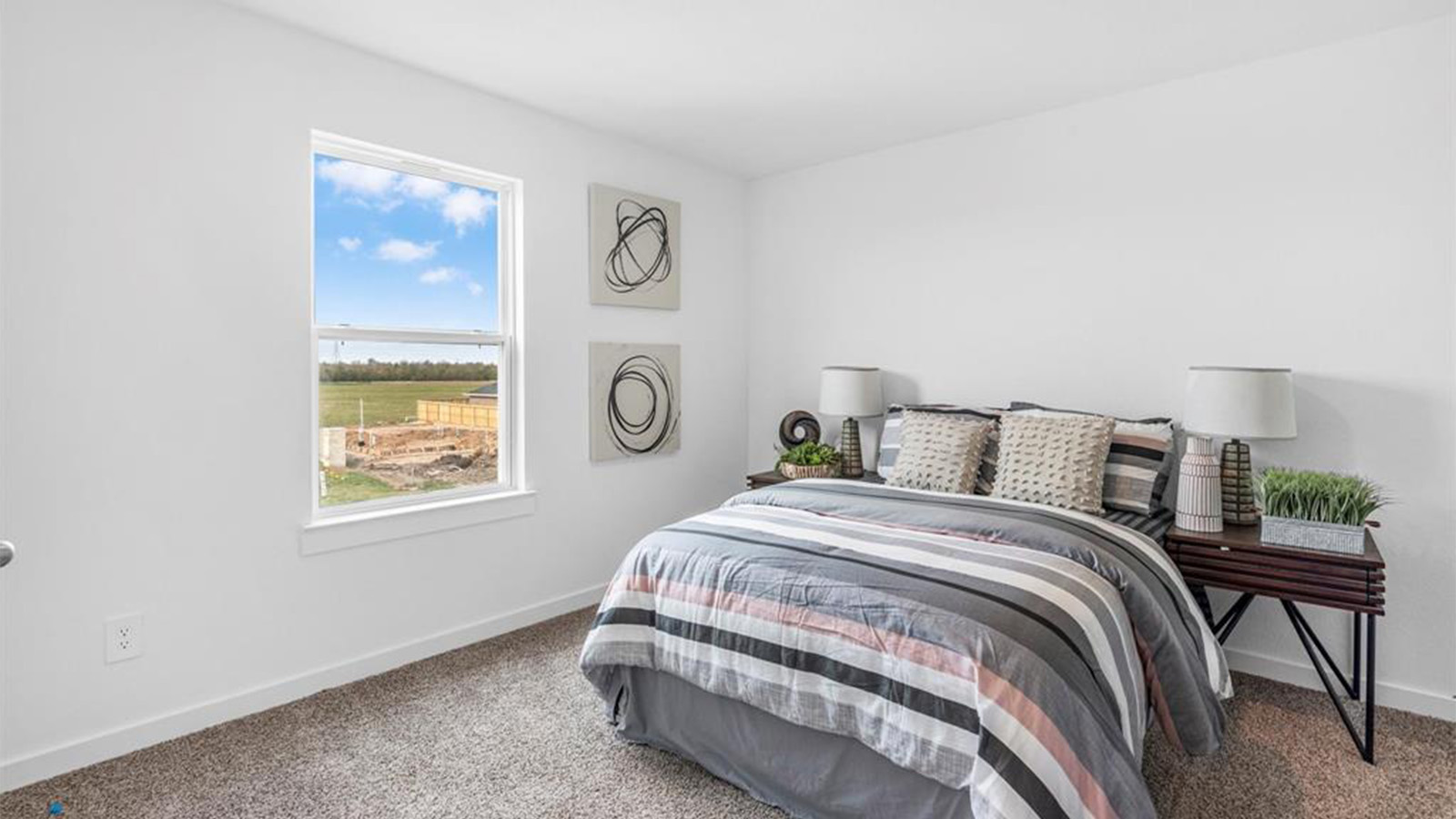 Comfortable guest bedroom featuring neutral-toned walls, carpeted flooring, and a separate closet.