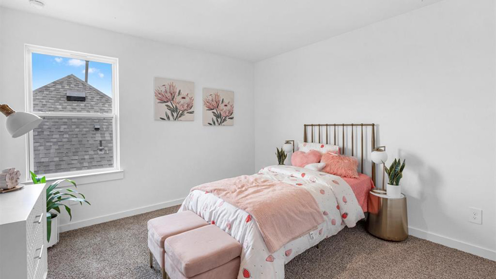 A vibrant kids' bedroom showcasing a neatly made bed, a stylish dresser, and a playful painting that adds charm.