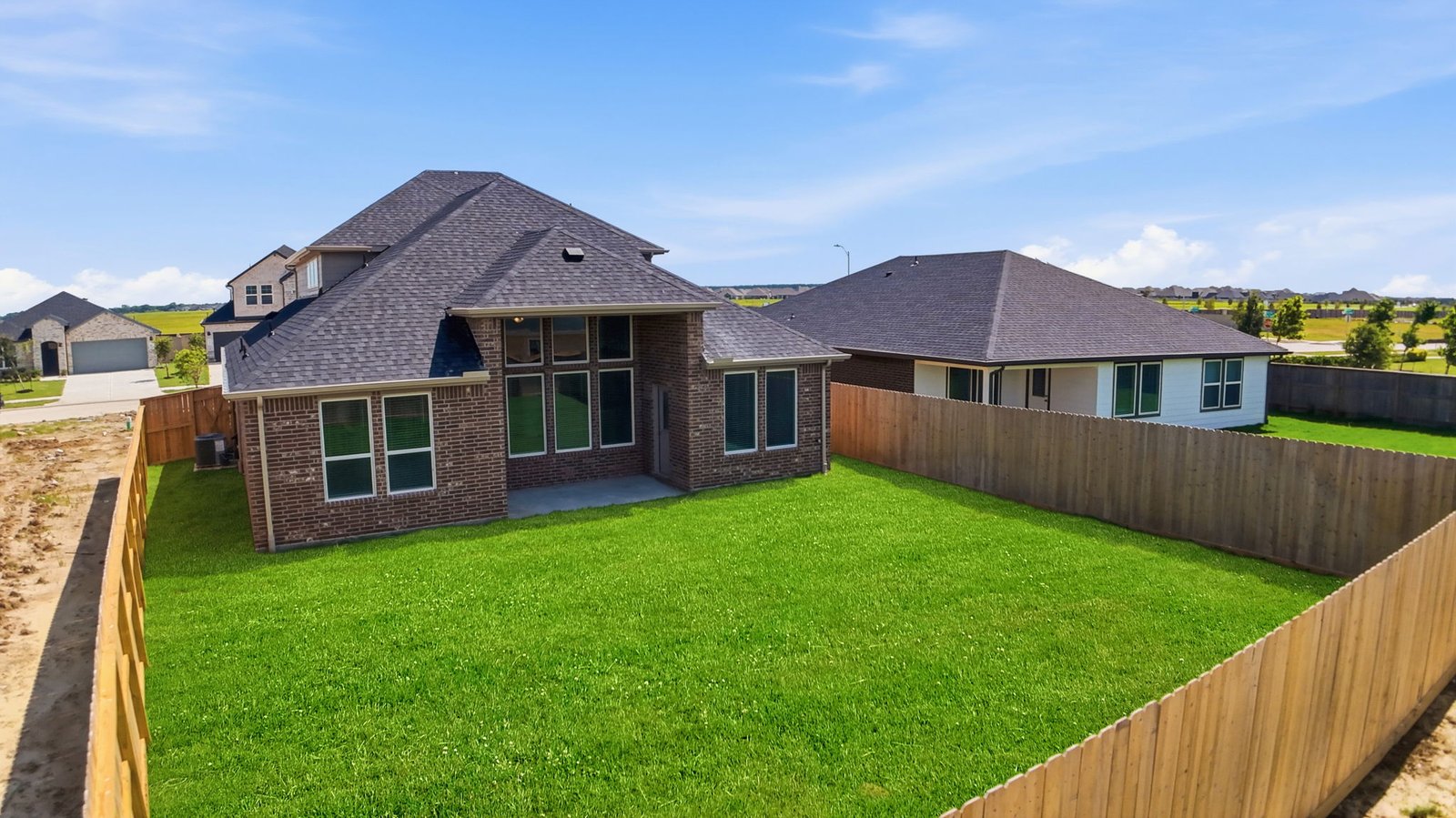 Large fenced-in backyard with a covered patio, perfect for outdoor entertaining.