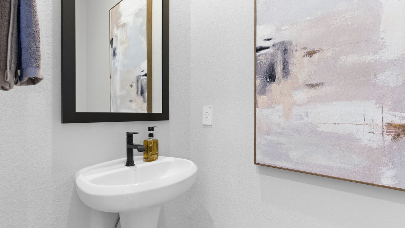 A decorated half bathroom downstairs for guests