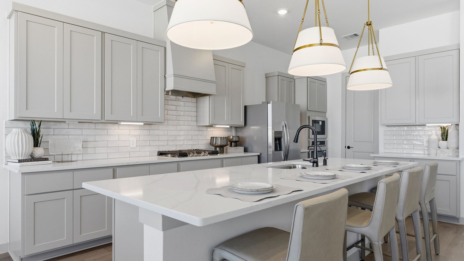 An open concept kitchen with an island with bar seating and access to the living and dining areas.