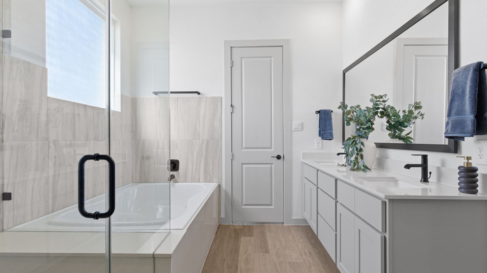 Primary bathroom with a glass-enclosed standing shower and separate soaking tub.