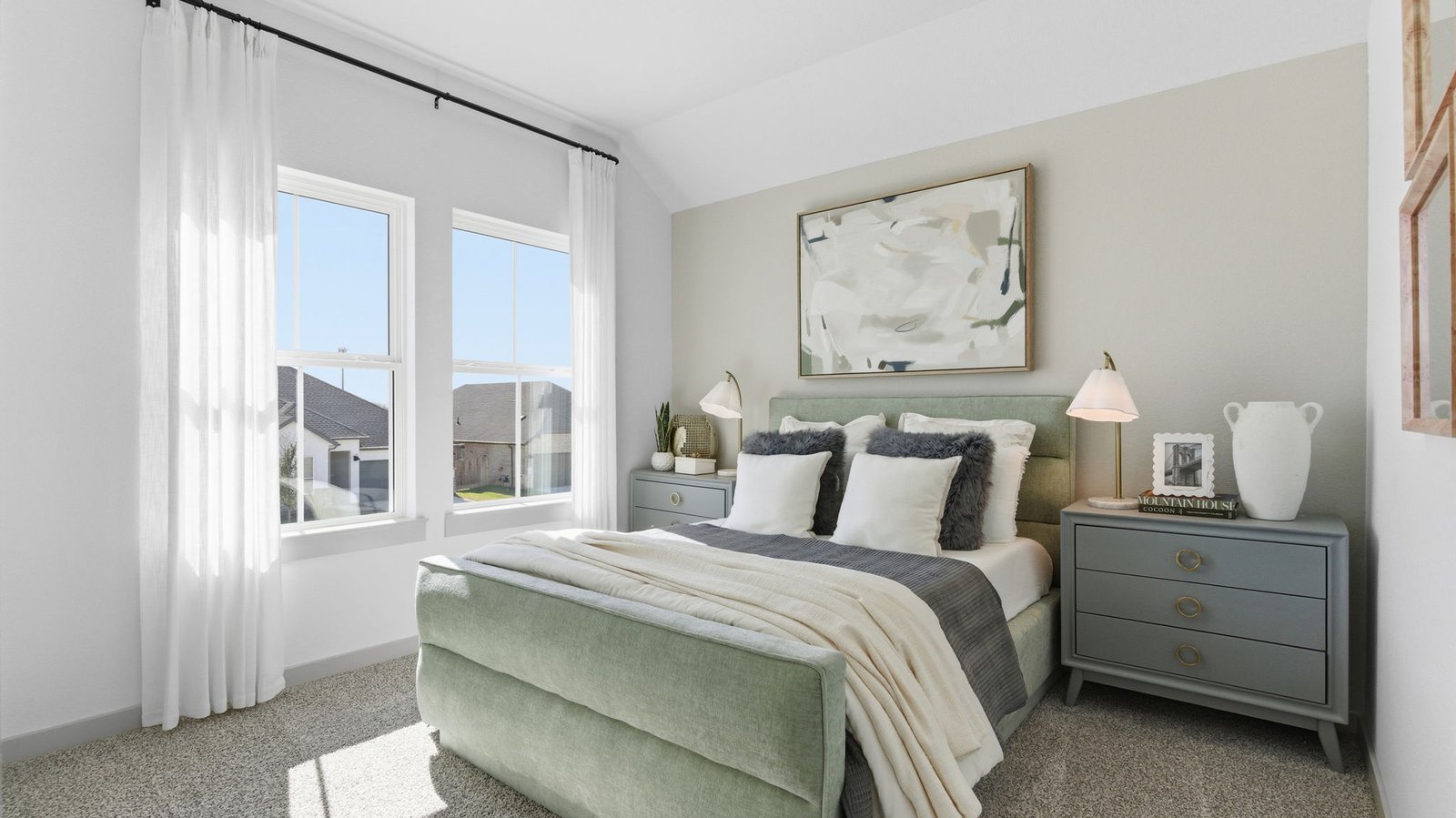 Comfortable guest bedroom featuring neutral-toned walls, carpeted flooring, and a separate closet.