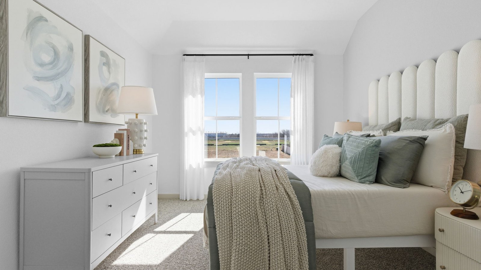 A spacious primary bedroom emphasizing open space and natural lighting with large windows.