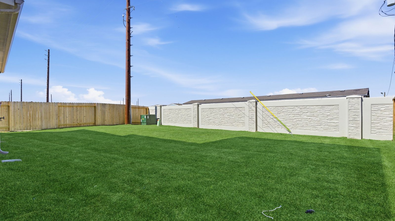 Large fenced-in backyard with a covered patio, perfect for outdoor entertaining.