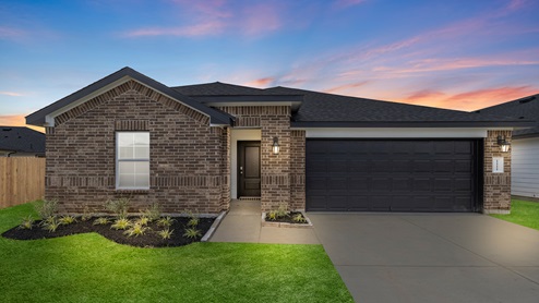 lakeway plan one story brick home at dusk