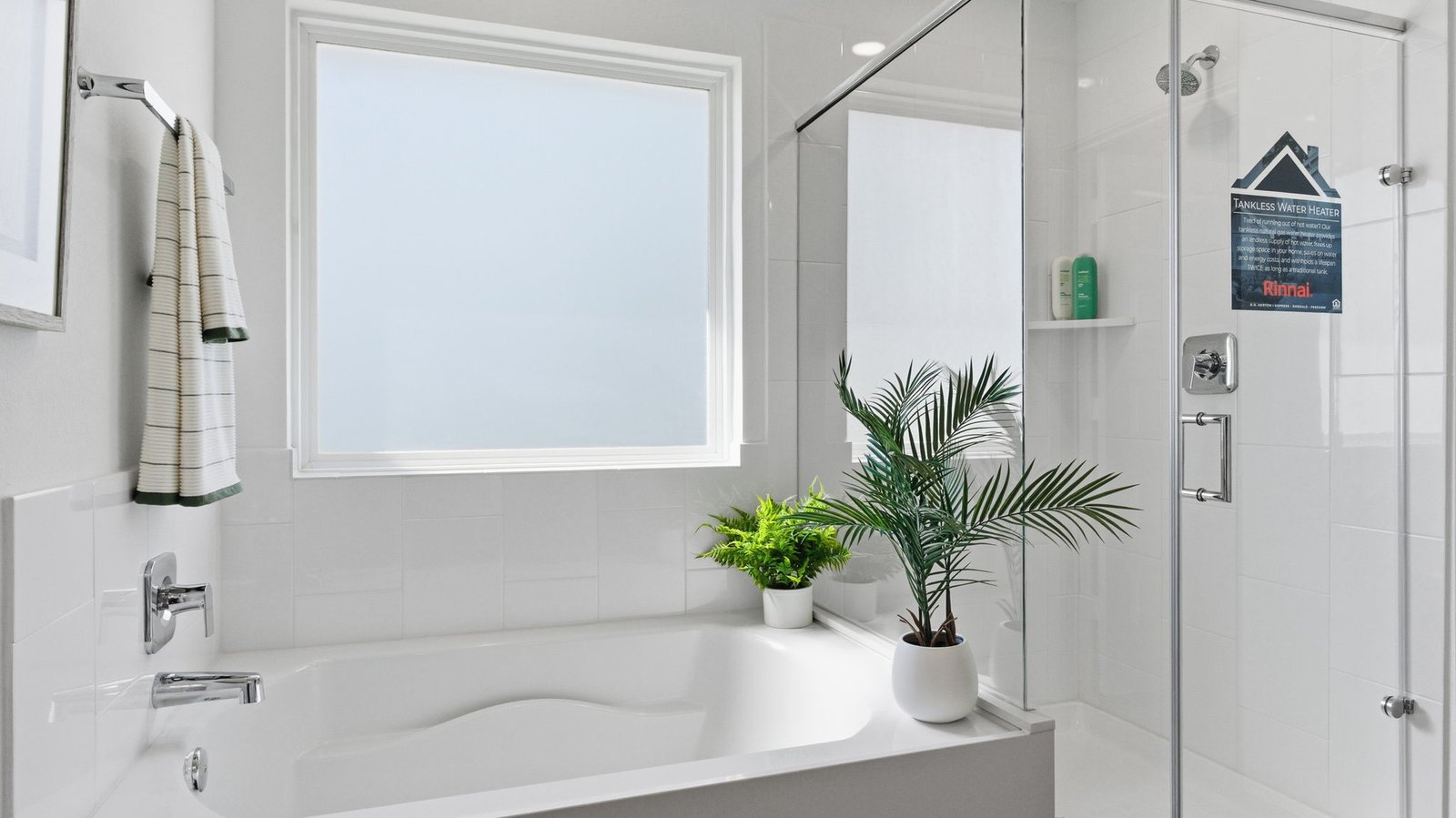 Modern primary bathroom with double vanities, granite countertops, and a glass-enclosed shower with a walk-in closet.