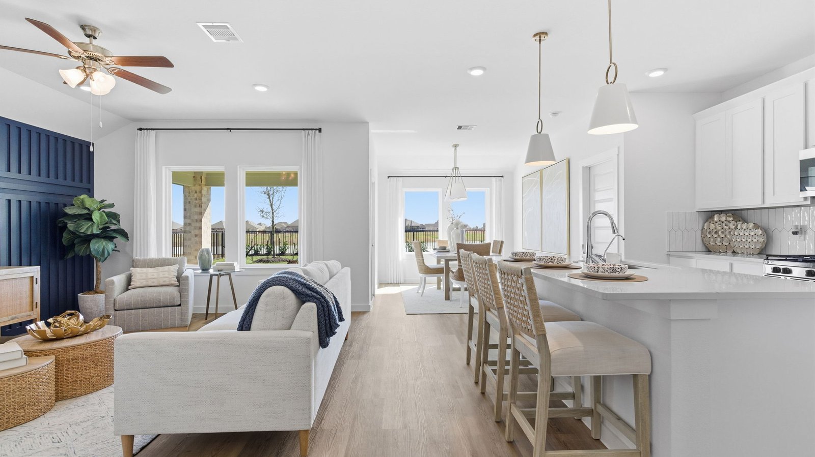 Bright and spacious kitchen with granite countertops, stainless steel appliances, and an island with bar seating.