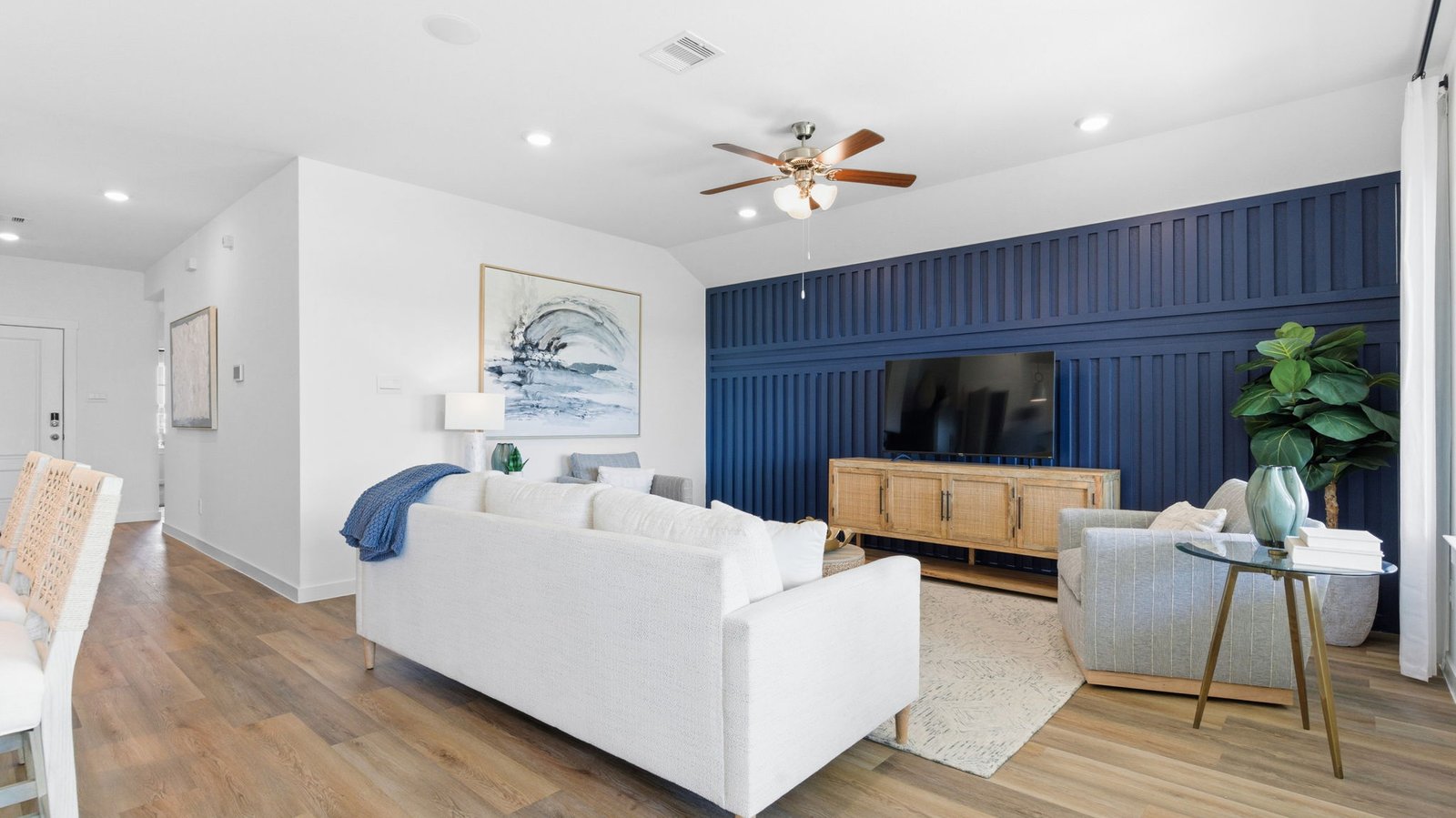 A well-organized living room that includes a kitchen and dining area, creating a warm and welcoming environment for gatherings.