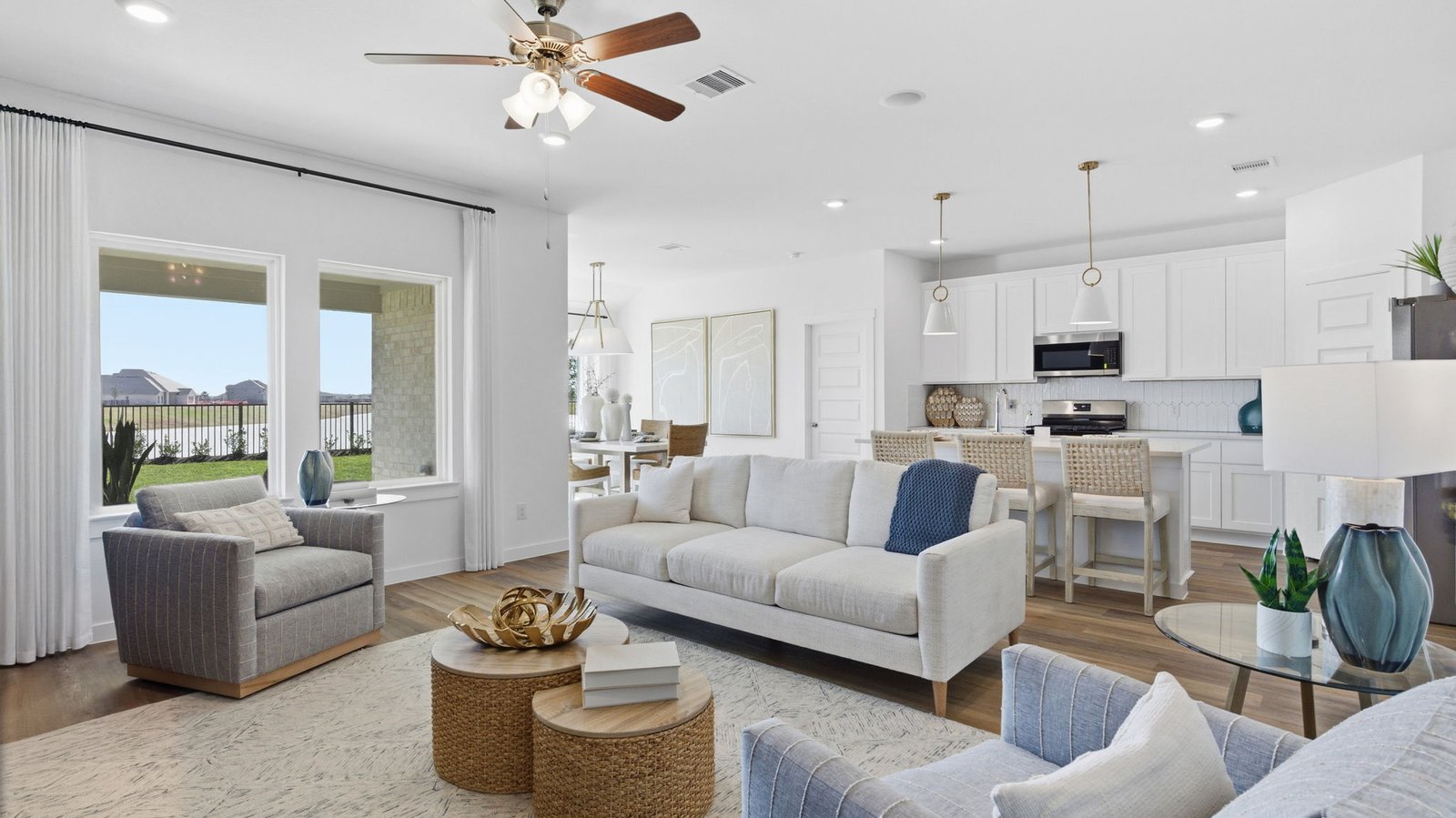 A well-organized living room that includes a kitchen and dining area, creating a warm and welcoming environment for gatherings.