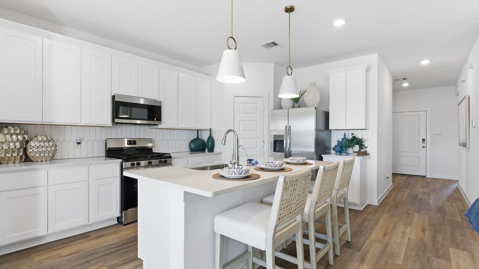 Bright and spacious kitchen with granite countertops, stainless steel appliances, and an island with bar seating.