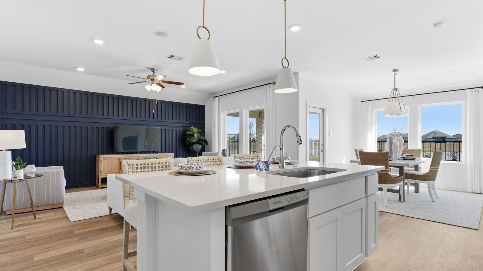 Bright and spacious kitchen with granite countertops, stainless steel appliances, and an island with bar seating.